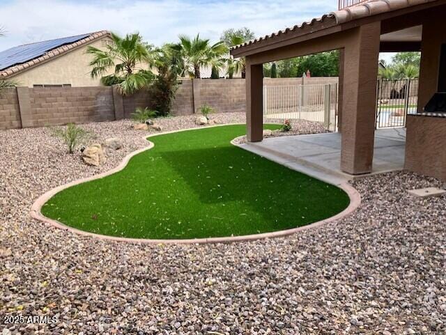 view of yard with a fenced backyard and a patio area
