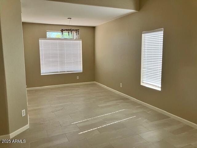 spare room featuring baseboards