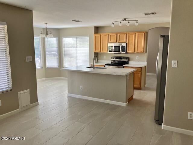 kitchen featuring visible vents, light countertops, a chandelier, a sink, and stainless steel appliances