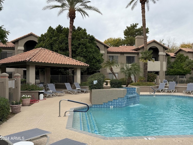 view of pool with a gazebo, pool water feature, and a patio