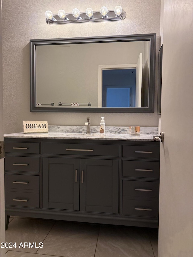 bathroom featuring tile patterned flooring and vanity