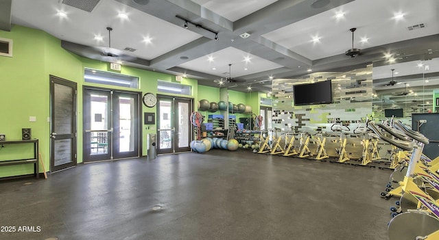 workout area featuring french doors and a high ceiling