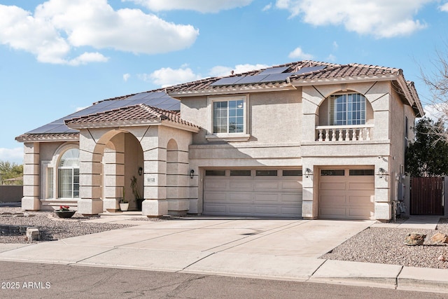 view of front of home featuring driveway, a tiled roof, an attached garage, fence, and stucco siding