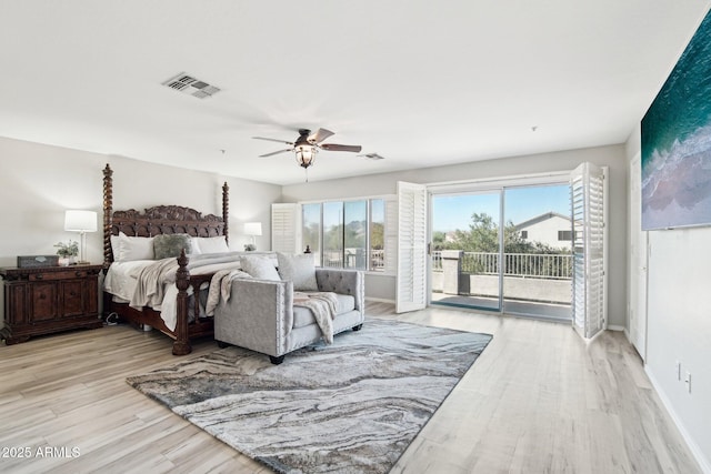 bedroom with access to exterior, baseboards, visible vents, and wood finished floors