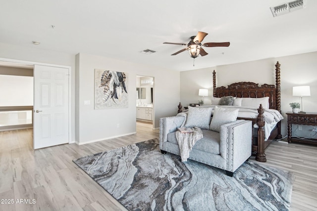 bedroom featuring ensuite bath, light wood-style flooring, visible vents, and a ceiling fan