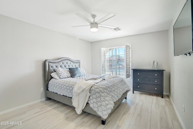 bedroom with light wood-style flooring, visible vents, ceiling fan, and baseboards