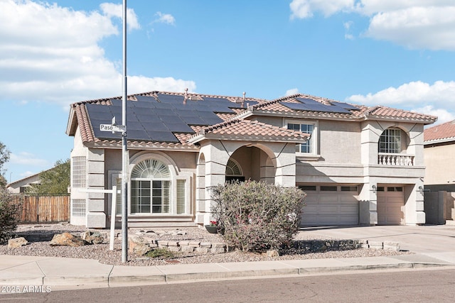 mediterranean / spanish-style home with a garage and solar panels