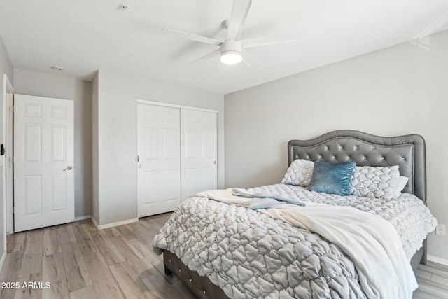 bedroom featuring a closet, baseboards, and light wood finished floors