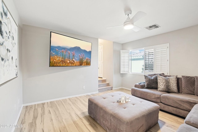 living room with ceiling fan and light hardwood / wood-style floors