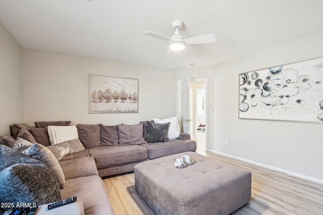 living room with ceiling fan and light hardwood / wood-style flooring