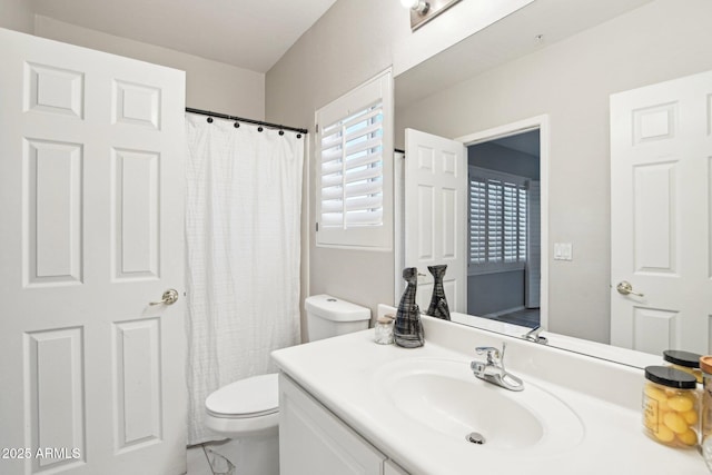 bathroom featuring vanity, toilet, and a shower with curtain