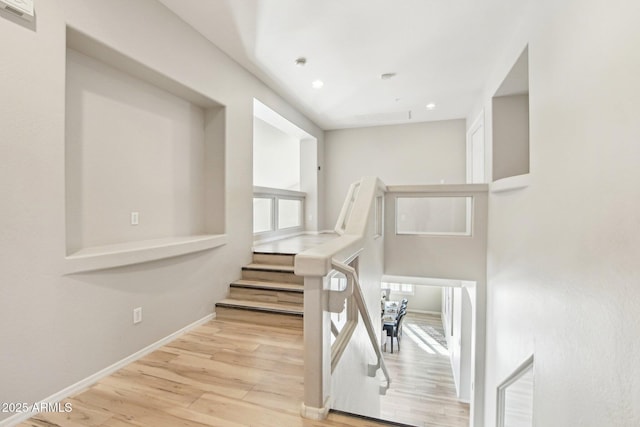 staircase with hardwood / wood-style flooring