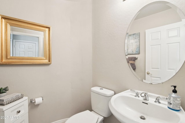 bathroom featuring sink and toilet