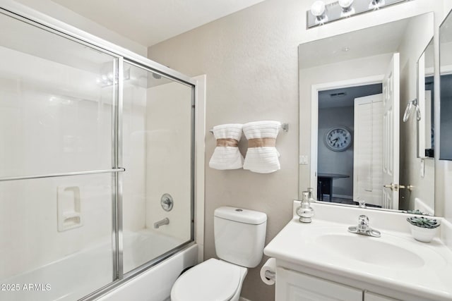 full bathroom with vanity, combined bath / shower with glass door, and toilet