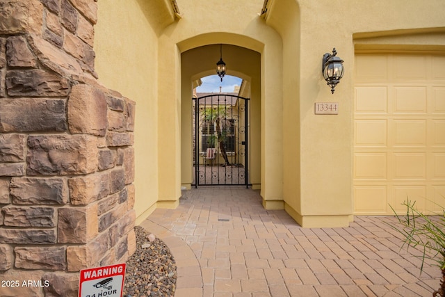 view of exterior entry with a garage