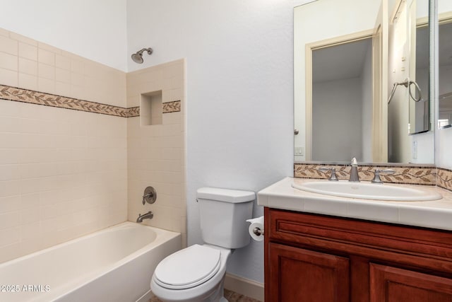 full bathroom with toilet, vanity, and tiled shower / bath combo