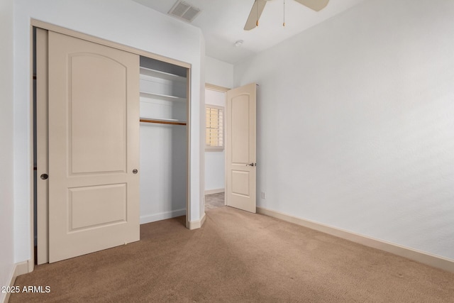 unfurnished bedroom with a closet, ceiling fan, and carpet floors