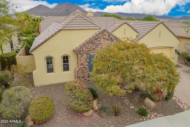 view of front of home with a mountain view and a garage