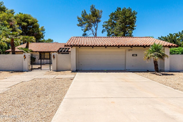 1108 N Oro Vis, Litchfield Park, AZ 85340 - mediterranean / spanish house featuring a tile roof, a gate, stucco siding, a fenced front yard, and an attached garage