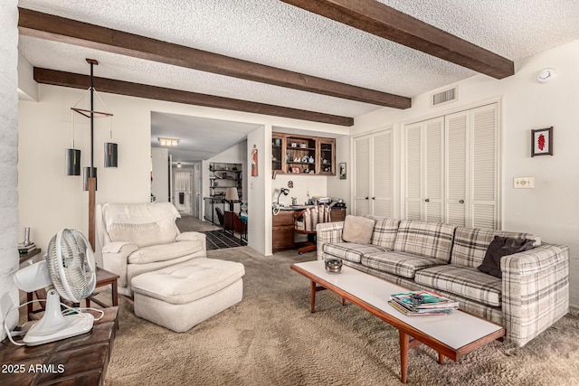1108 N Oro Vis, Litchfield Park, AZ 85340 - carpeted living room featuring beam ceiling and a textured ceiling
