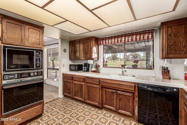 1108 N Oro Vis, Litchfield Park, AZ 85340 - kitchen featuring black appliances and backsplash