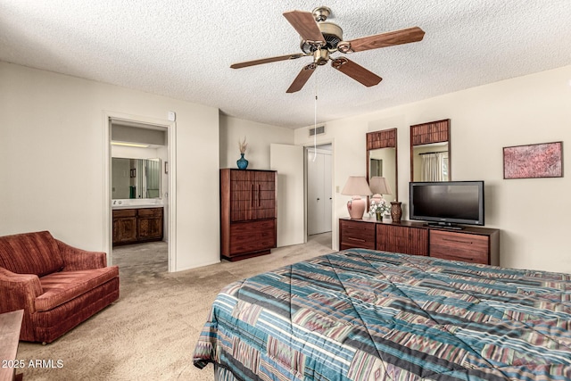 1108 N Oro Vis, Litchfield Park, AZ 85340 - bedroom with light colored carpet, a textured ceiling, connected bathroom, and ceiling fan