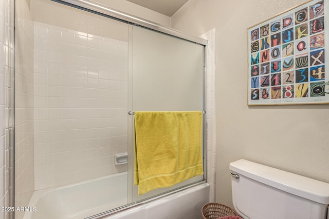 1108 N Oro Vis, Litchfield Park, AZ 85340 - bathroom featuring shower / bath combination with glass door and toilet