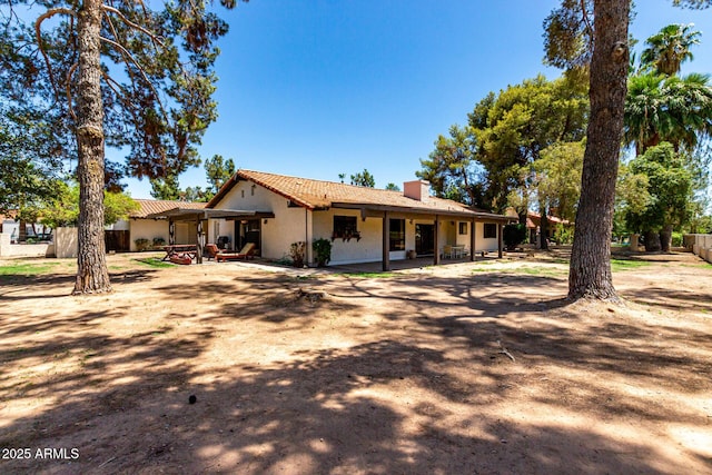 1108 N Oro Vis, Litchfield Park, AZ 85340 - back of house with a chimney, a patio area, and stucco siding