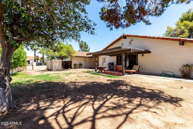 1108 N Oro Vis, Litchfield Park, AZ 85340 - back of house featuring a tile roof, stucco siding, and a patio area