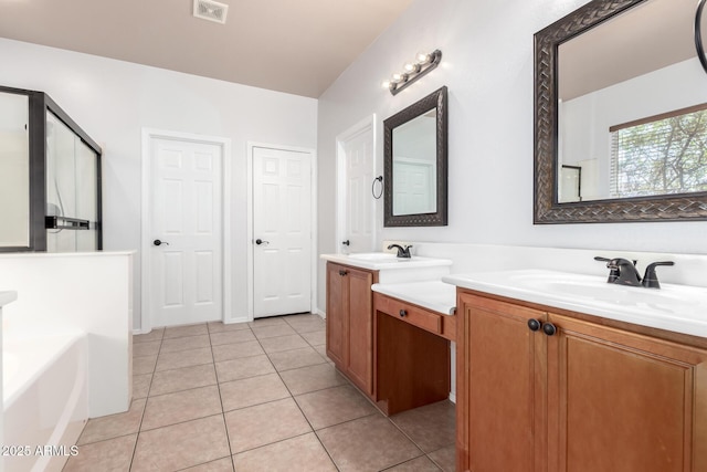 bathroom featuring double vanity, tile patterned floors, visible vents, and a sink