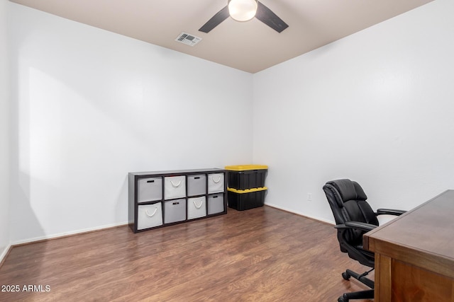 office featuring baseboards, ceiling fan, visible vents, and wood finished floors