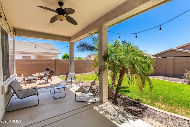 view of patio with a fenced backyard and a ceiling fan