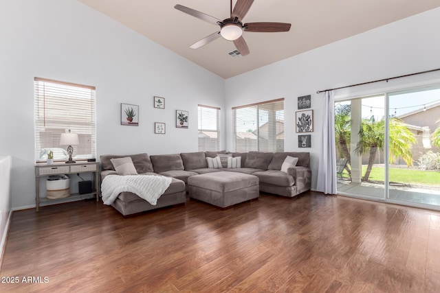 living area featuring high vaulted ceiling, ceiling fan, wood finished floors, and visible vents