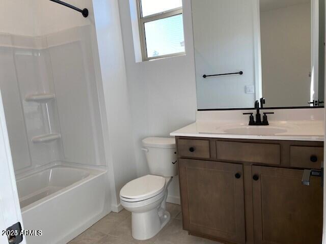 bathroom featuring tile patterned flooring, shower / tub combination, toilet, and vanity