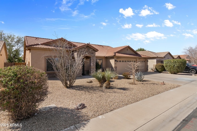 view of front facade featuring stone siding, stucco siding, an attached garage, and a tile roof