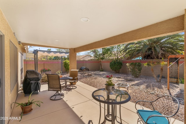 view of patio / terrace with outdoor dining space, area for grilling, and a fenced backyard