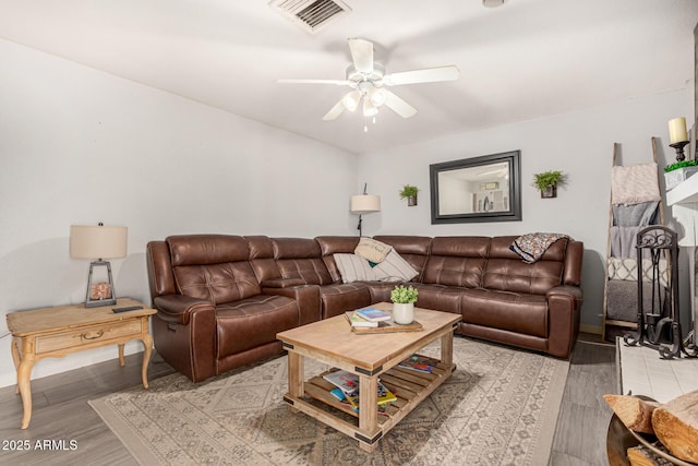 living room with ceiling fan and light wood-type flooring