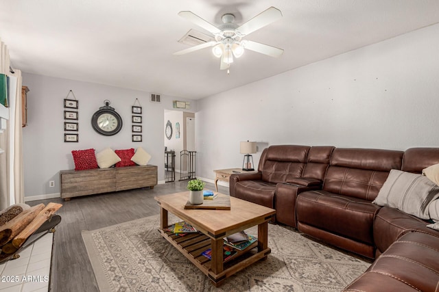 living room with light hardwood / wood-style flooring and ceiling fan