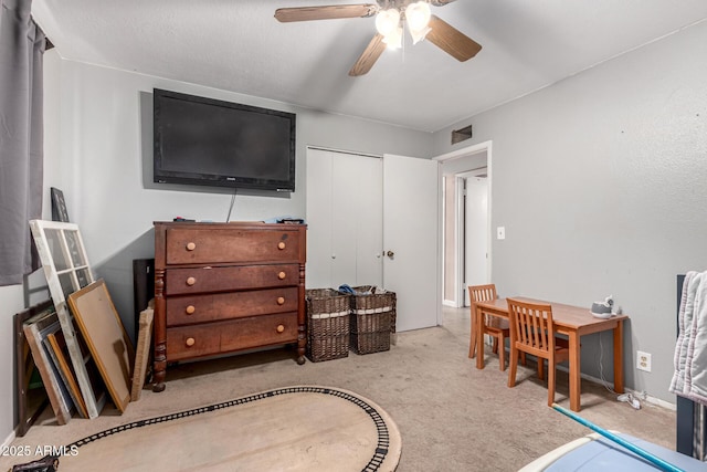 carpeted bedroom with a closet and ceiling fan