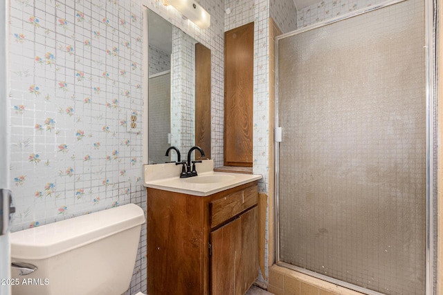 bathroom featuring toilet, vanity, and walk in shower