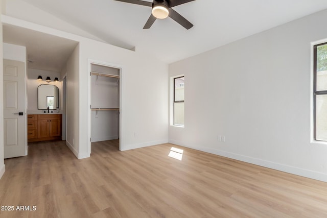 14239 N Edgeworth Dr Unit A, Fountain Hills, AZ 85268 - unfurnished bedroom featuring light wood finished floors, baseboards, lofted ceiling, a spacious closet, and a closet
