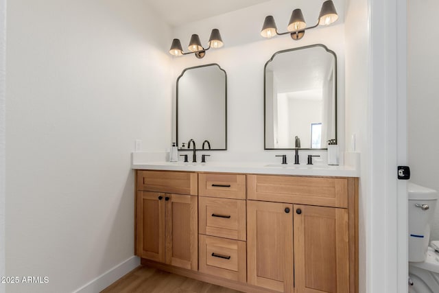 14239 N Edgeworth Dr Unit A, Fountain Hills, AZ 85268 - full bathroom with toilet, double vanity, wood finished floors, and baseboards