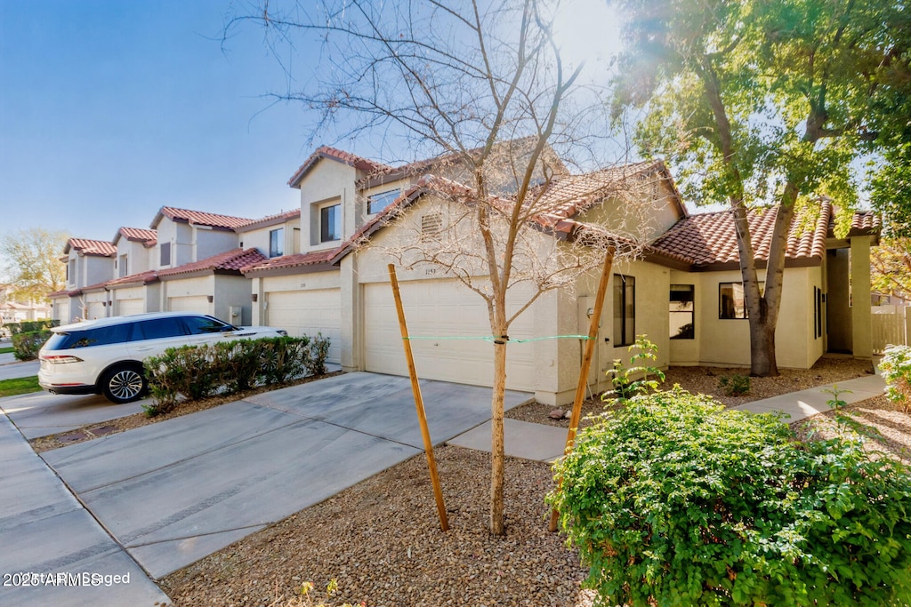 mediterranean / spanish-style home with a garage