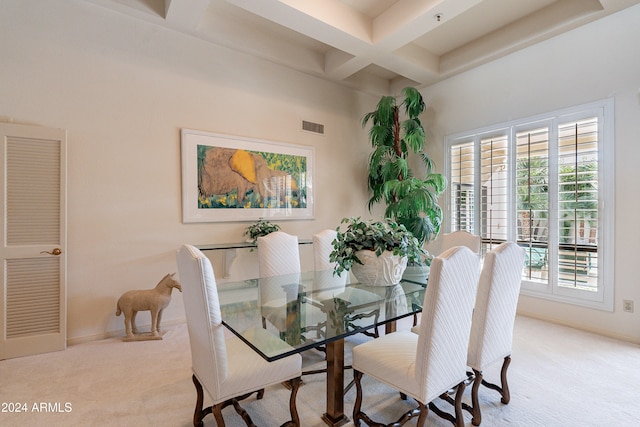 carpeted dining room with beam ceiling and coffered ceiling