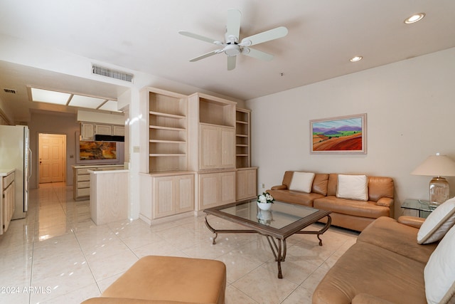 living room with ceiling fan and light tile patterned floors