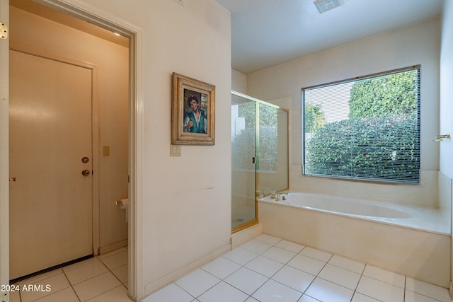 bathroom featuring tile patterned floors and separate shower and tub