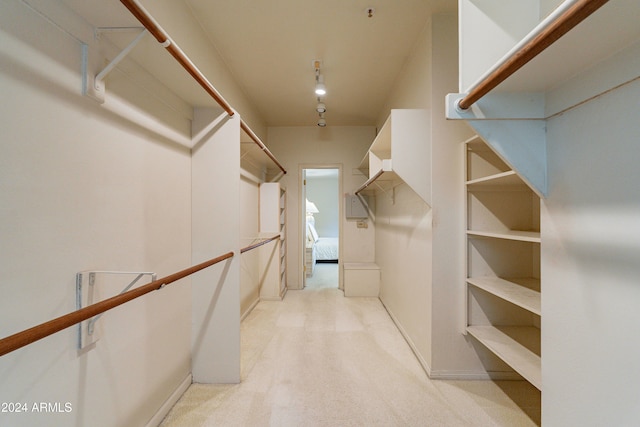 spacious closet featuring light carpet