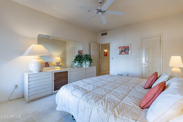 bedroom featuring ceiling fan and light carpet