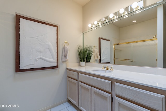 bathroom featuring tile patterned flooring, vanity, and a shower with door