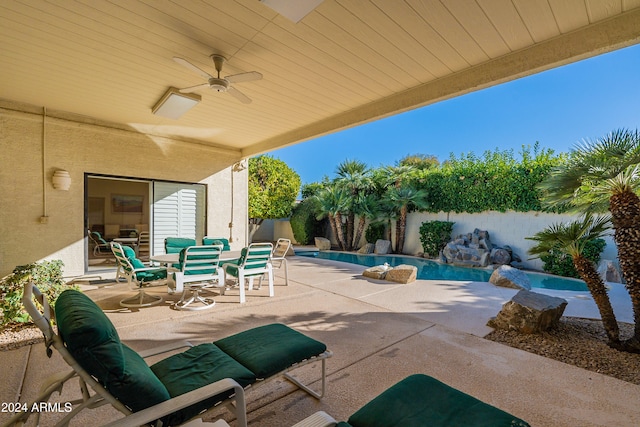 view of patio with a fenced in pool and ceiling fan